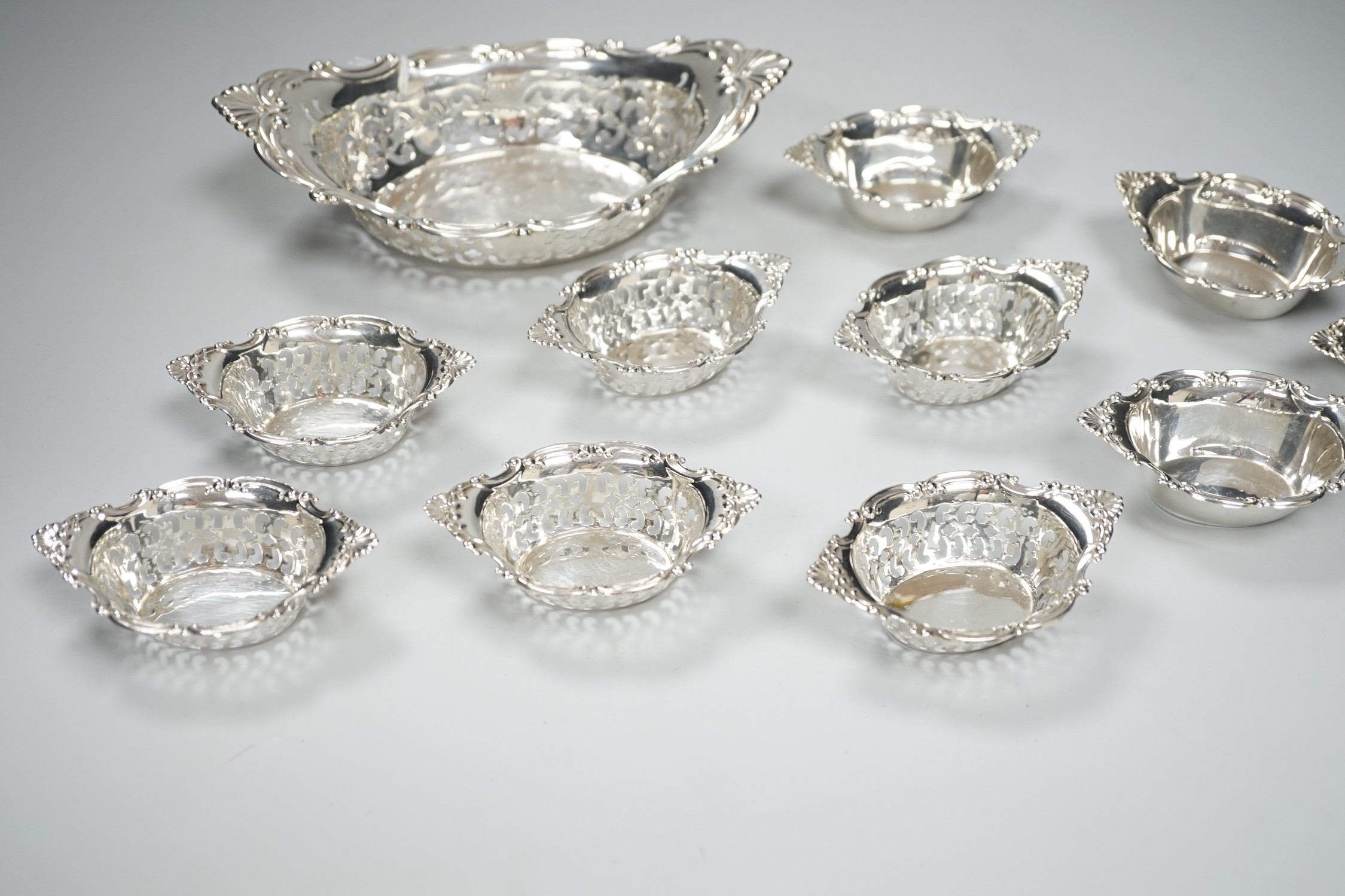 A set of ten Canadian Birks pierced sterling nut dishes, 97mm and a similar larger dish, 20.8cm, 11oz.